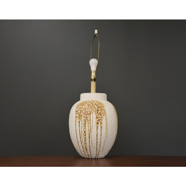 A mid century modern ceramic drip glaze table lamp. Height is measured to the top of the finial. 12.5” diameter. 33” tall.