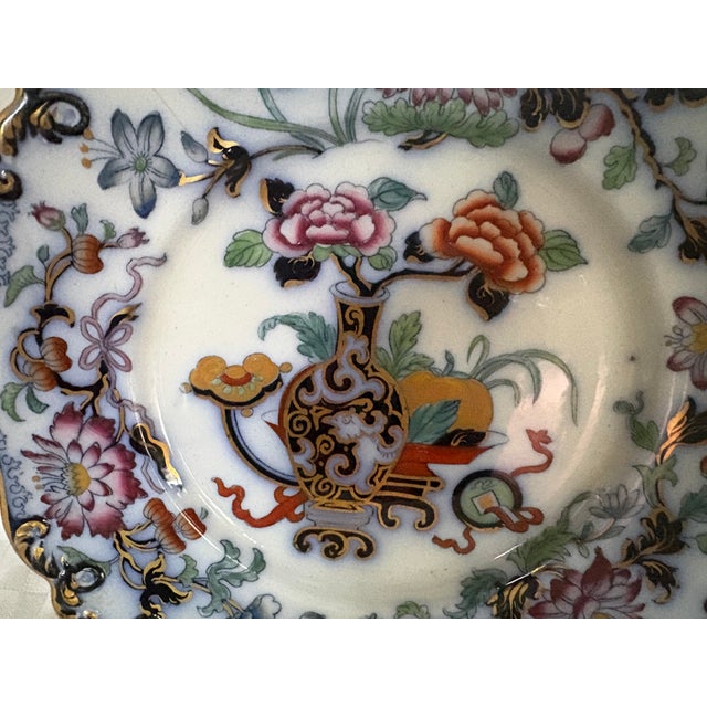 An antique Ridgway earthenware plate in the Noma pattern; circa 1835. This Chinoiserie style design has a central gilded...