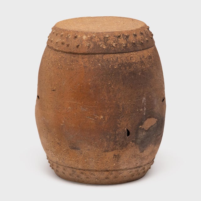 This terracotta garden stool from the early 20th century honors tradition with its simple, drum-form shape. A pattern of...