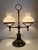 Vintage double arm student lamp with brass base and white milk glass shades.