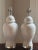 An elegant pair of circa 1960s ceramic ginger jar table lamps in a soft white, glossy glaze and chrome accents. These...