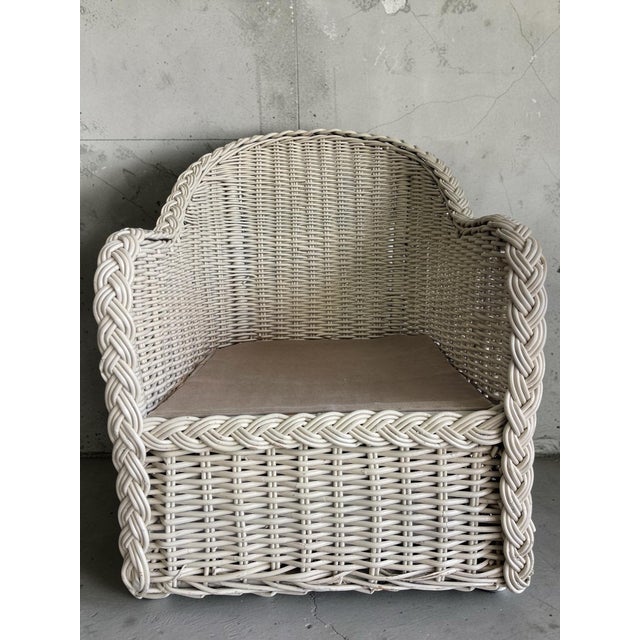 Vintage rattan barrel back chair frame featuring large scale braid detail and a sculptural wraparound form. Off-white...