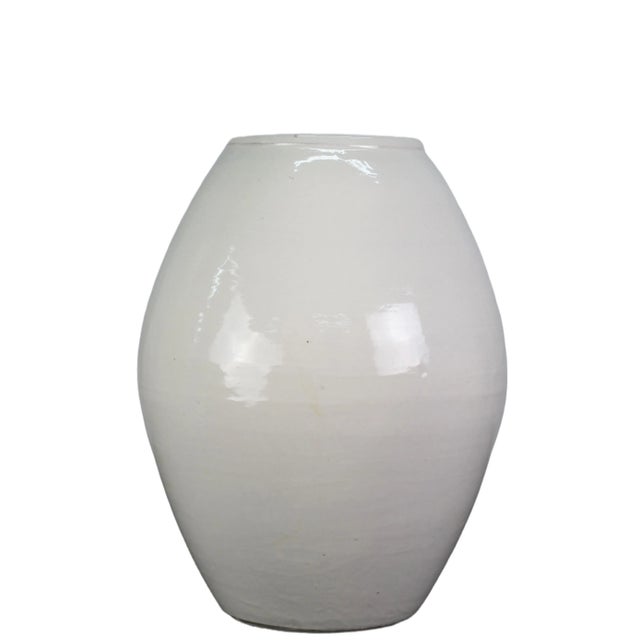 The white oblong jar is a handmade pottery. With its unique shape, this jar is perfect for adding a touch of elegance to...