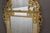 Regency mirror with gilt and carved wooden side panels, double-framed with moldings known as "Bérain" moldings, decorated...