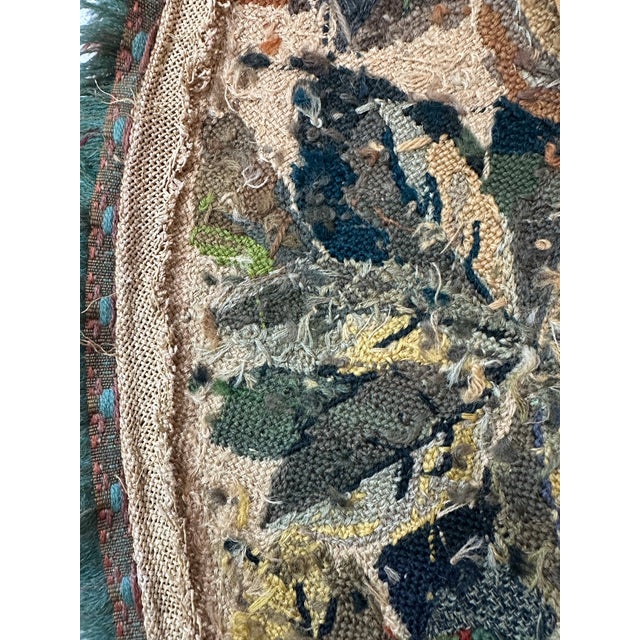 This is a beautifully crafted round needlepoint tapestry rug or textile rich in botanical elegance and classic European...