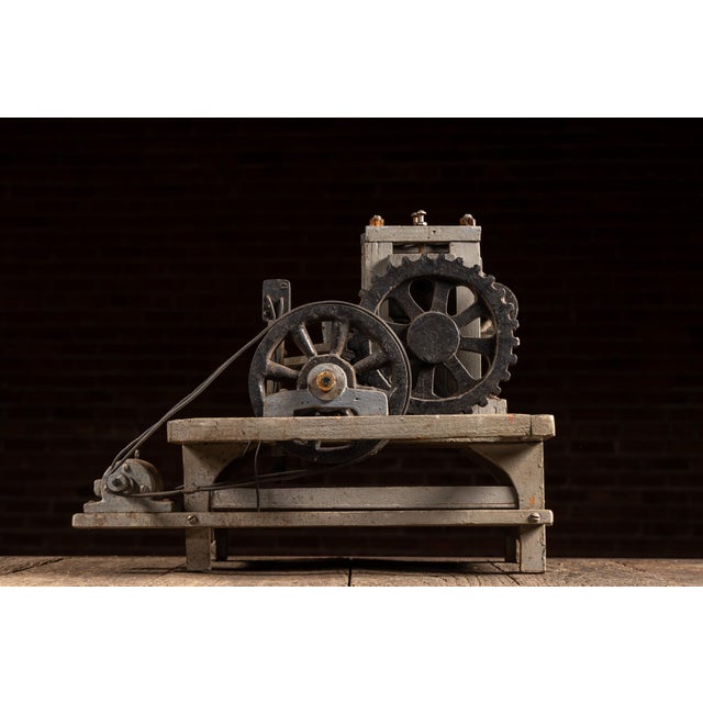 Compact, bench-mounted salesman's model demonstrating a mechanical tube flaring process, likely used in the presentation...