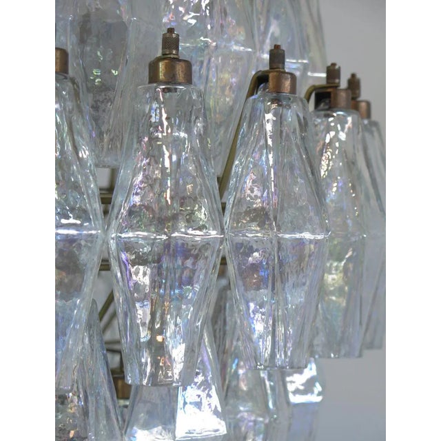 This is an elegant Italian pendant light made from 140 iridescent Murano glasses ('poliedri'). The structure is in gold...