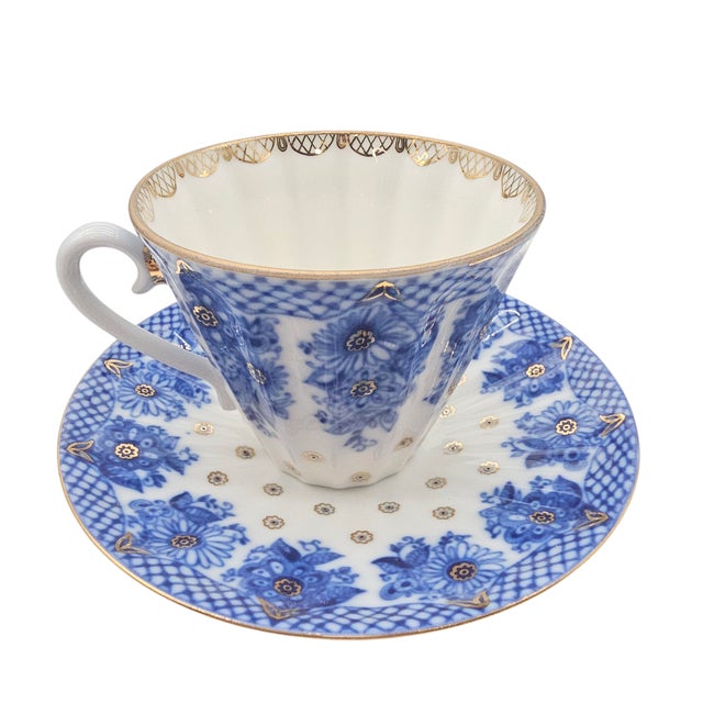 This hand-decorated Lomonosov porcelain teacup and saucer set, a delicate treasure from St. Petersburg, captures the...