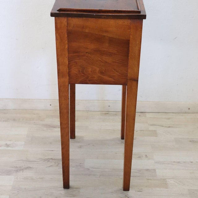 We present this refined antique Italian bedside table or nightstand dating back to the early 19th century. Made of solid...