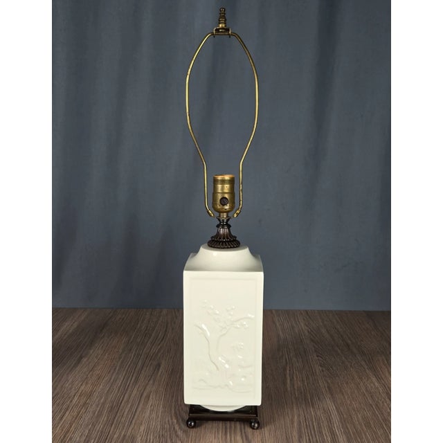 Blanc de Chine porcelain table lamp with cast bronze trim and base. Classic design by Crest of Chicago, stamped on the...