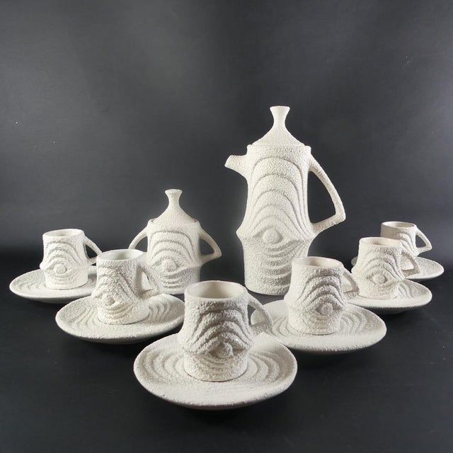 A very unusual mocha service from the 1970s. 6 cups, approx. 6 cm high 6 saucers, approx. 12.8 cm high 1 pot with lid,...