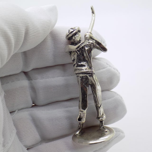 A dynamic vintage miniature depicting a golf player mid swing, handmade in Italy between the 1980s and 1990s in genuine...
