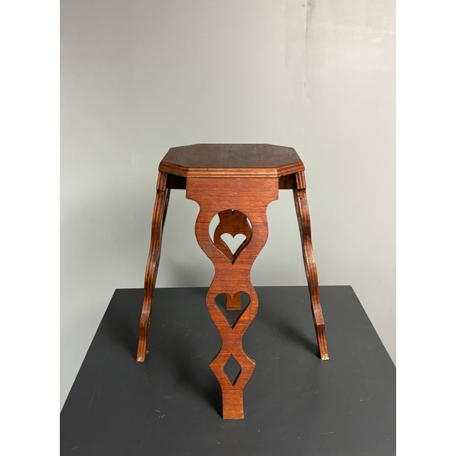 French artisanal octagonal plant stand in laminated hardwoods with decorative inlay detail. Constructed from contrasting...