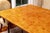 A stunning custom Art Deco style rectangular dining table in a highly polished bird’s-eye burl wood maple with a warm...