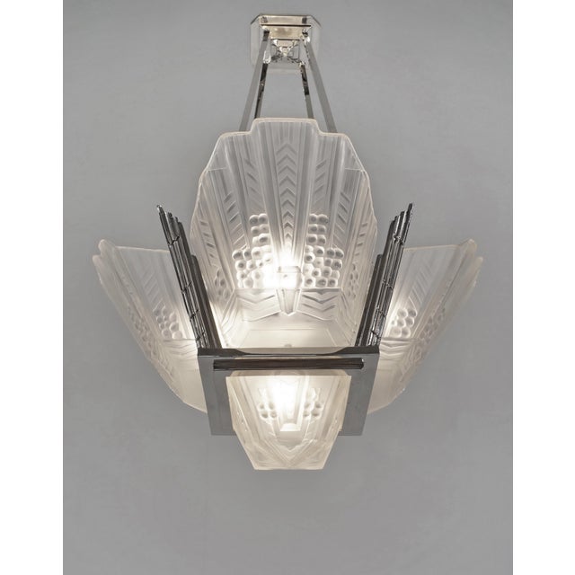 EJG chandelier A French 1925-1935 art deco chandelier in nickel plated solid brass or bronze holding four panels and a...