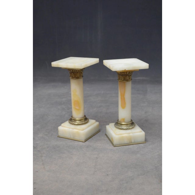 P081 a rare pair of antique marble columns in white veined marble, each having a square platform top (one with small chip...