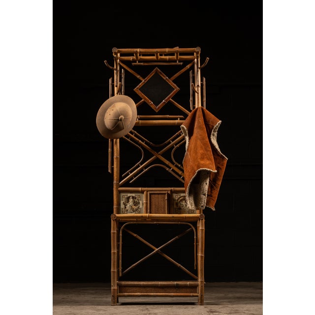 c. 1880s - 1890s Antique bamboo hall tree with vanity mirror. This piece features, in addition to the mirror, two small...