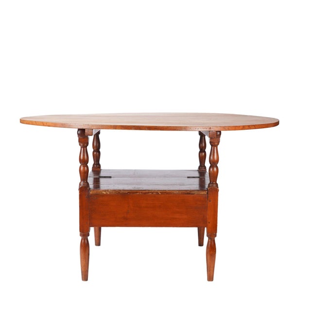 Delaware Valley metamorphic Monk's Bench tilt top settle base table in cherry wood. The two board top is attached to the...