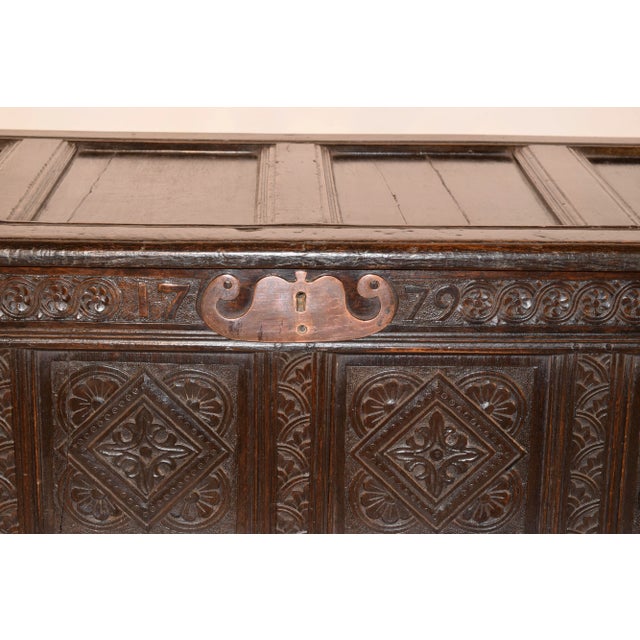 Late 18th century oak blanket chest from England. The chest has a quadruple paneled top with molded edges, which lifts to...