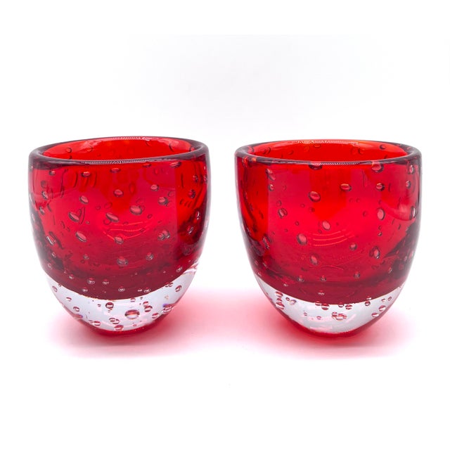 Murano glass vase set made of mouth-blown red glass with distinctive, large, trapped air bubbles (Bullicante). These vases...