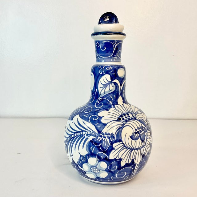 Vintage Home is pleased to offer this hand-painted Italian Decanter. The design is a floral botanical in Blue and White....
