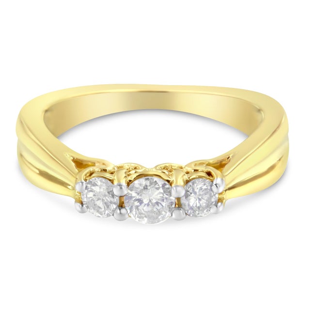 Gorgeous three stone ring that displays a classic and graceful design. The delicate prongs embrace three brilliant round-...
