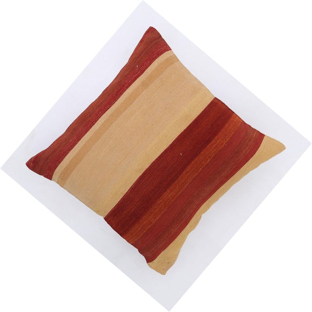 A one-of-a-kind handwoven wool kilim floor pillow featuring a warm gold ground with bold red and rust stripes. Fully...