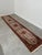 Beautiful long vintage runner rug with an exceptionally detailed traditional Oriental design. The rug features a warm...