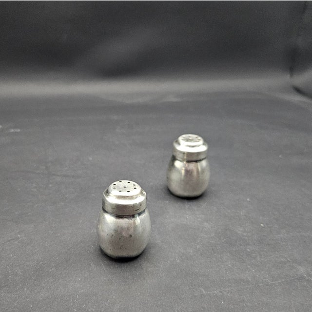 This marvelous pair of individual bulbous shaped salt and pepper shakers are created in gorgeous 900 coin silver by the...