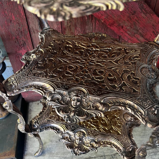 This late 19th-century rare antique brass and metal three-tiered piece serves as a plant stand or accent table, featuring...