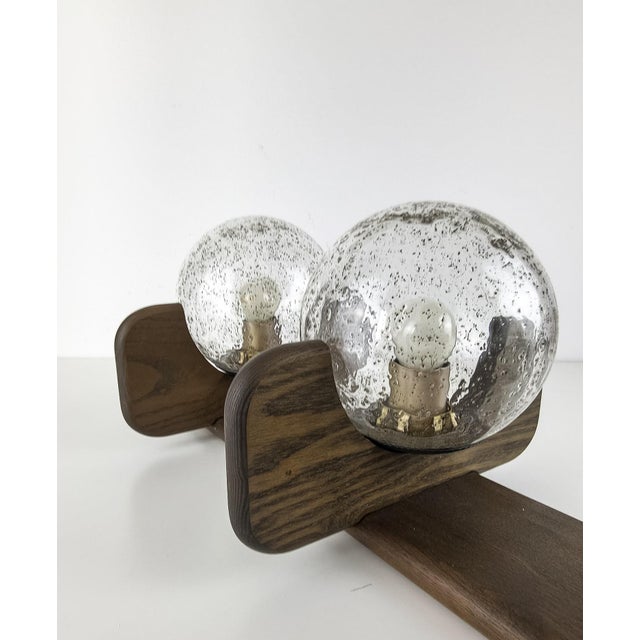 Beautiful vintage Kaiser wall or ceiling light featuring three glass globes with fused flecks mounted on a warm-toned...