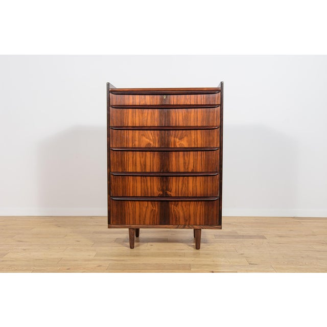 This rosewood dresser was manufactured in Denmark during the 1960s. The piece is an excellent example of Scandinavian Mid-...