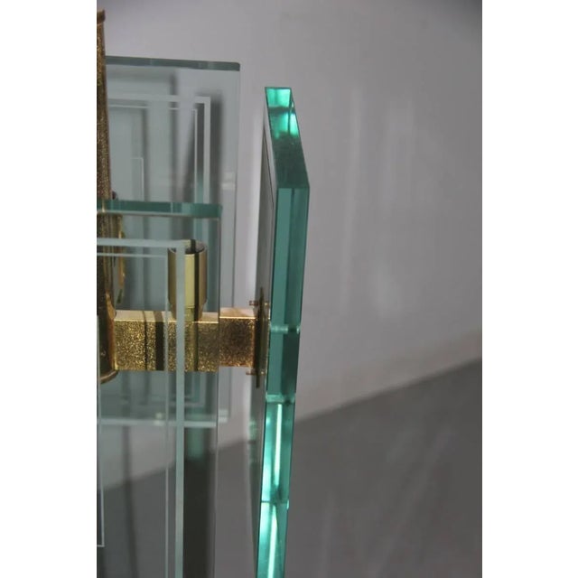 This chandelier features large sheets of glass and a brass structure. European Plug (up to 250V).The wiring of this item...