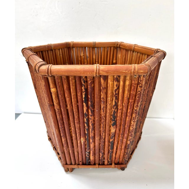 A substantial vintage bamboo planter featuring vertical reed construction and an octagonal silhouette. The warm natural...