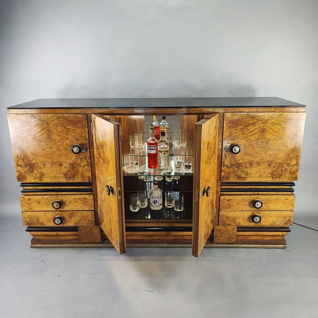 Art Deco bar cabinet from the 1940s. Made of elm burl with black lacquered wood inserts, a 10mm black glass shelf, black...