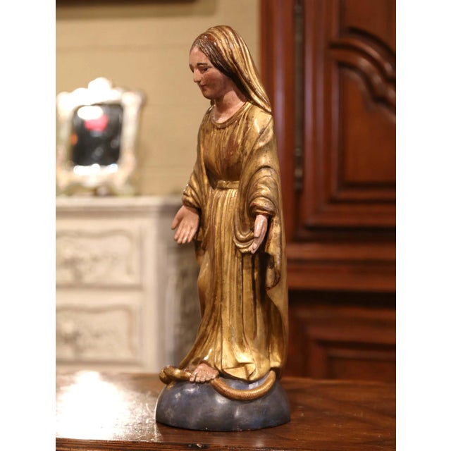 This finely carved antique devotional statue depicts the Virgin Mary in the traditional Immaculate Conception iconography....