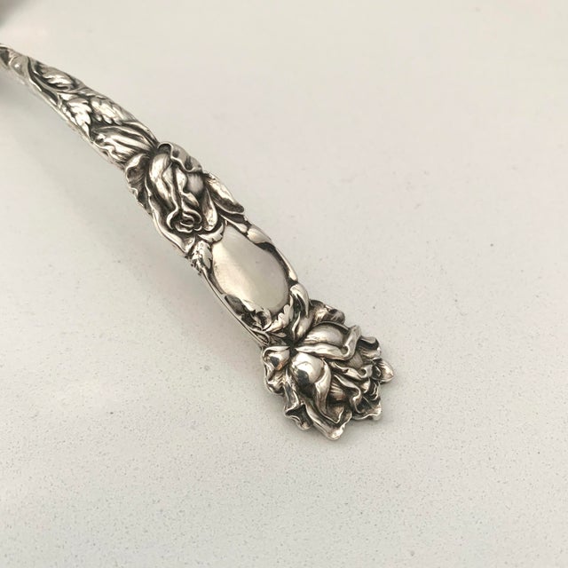 Made by American Silver Company Alvin and introduced in 1903. The art nouveau floral decoration on this small ladle is...
