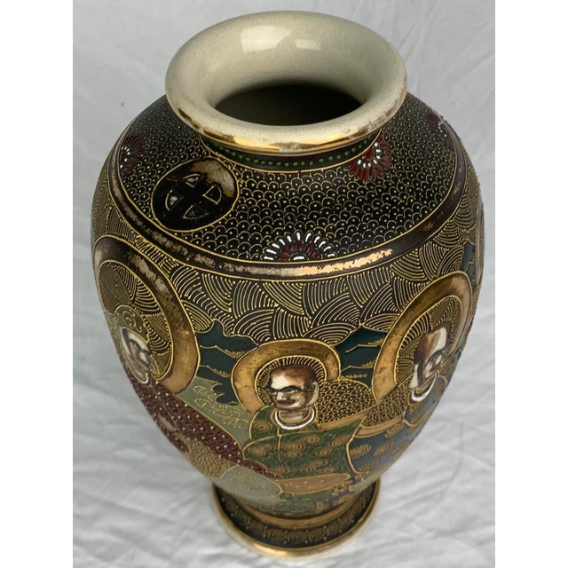 Antique early-20th-century Japanese Satsuma export vase featuring hand-painted depictions of Buddhist arhats or sages.It...