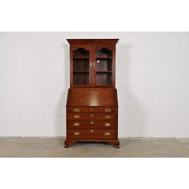 A beautiful Georgian or Chippendale style bureau with drop front secretary desk and bookcase hutch top By Henkel Harris...