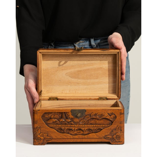 This mid 20th century box from Japan is finished in amber, worked in wood. Its carved, hand-carved detailing gives the...