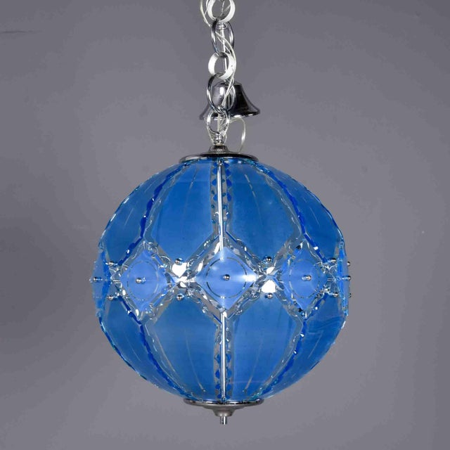 This spherical pendant light is composed of shaped and cut blue Murano glass panels arranged in a diamond lattice, secured...