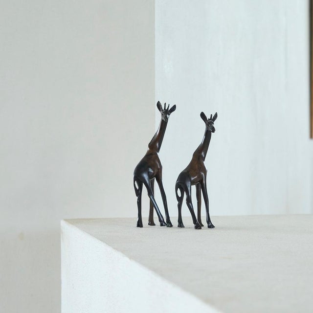Pair of Giraffe Sculptures in Coromandel Wood 1930s. Wonderful elegant pair of giraffe sculptures hand carved out of...