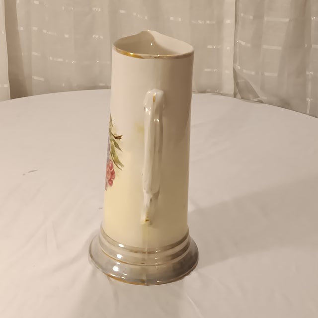 Beautiful Vintage Limoges Style Pitcher With Grape Motif. This lovely ceramic pitcher has gilded gold rim and base. With a...