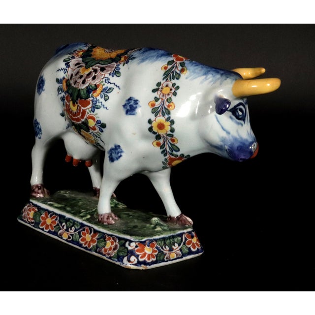 Dutch Delft Polychrome Model of a Cow, Circa 1760 The Dutch Delft pottery figure depicts a standing cow on a hollow...