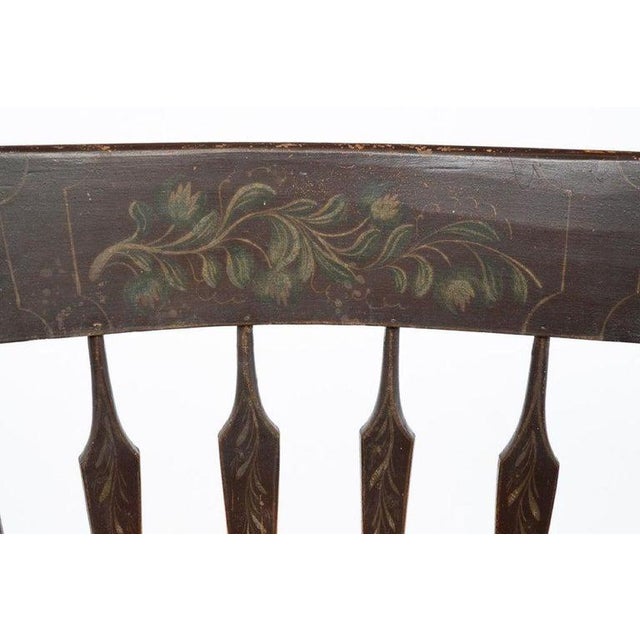 PAINT-DECORATED ARROW BACK ROCKING ARMCHAIR. American, First quarter 19th Century. Mixed woods. Eared stiles, plain crest,...