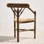 Three-legged oak armchair from the 1930s. The chair features precise details with a woven paper cord seat. with some...