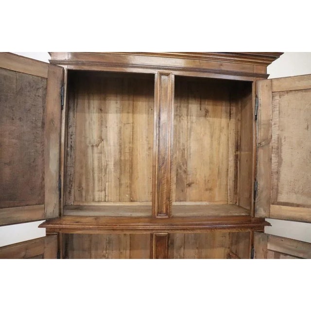 Important and rare antique solid walnut cabinet, 19th century. Characterized by a refined hand carving of the wood on the...