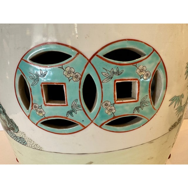 Very pretty pair of vintage Chinese garden seats having decoration in turquoise, celadon, pink and yellow. Note: Will...