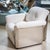 Seating group comprising a three-seater sofa and two armchairs featuring reflective stainless steel backrests and arm...