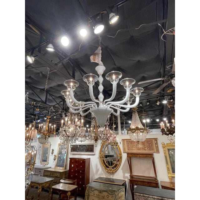 Stylish modern white and clear Murano glass chandelier with 12 arms. A very impressive and beautiful chandelier that makes...